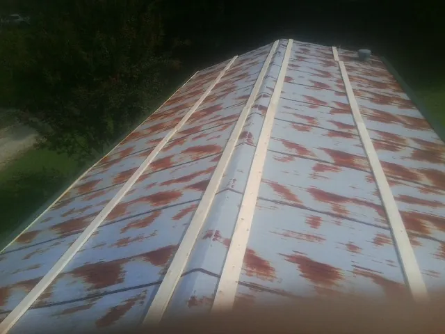 Rusted metal roof panels with new wood purlins before replacement — Storm Damage Roof Repair in Schuylkill Haven by Roofing Brothers