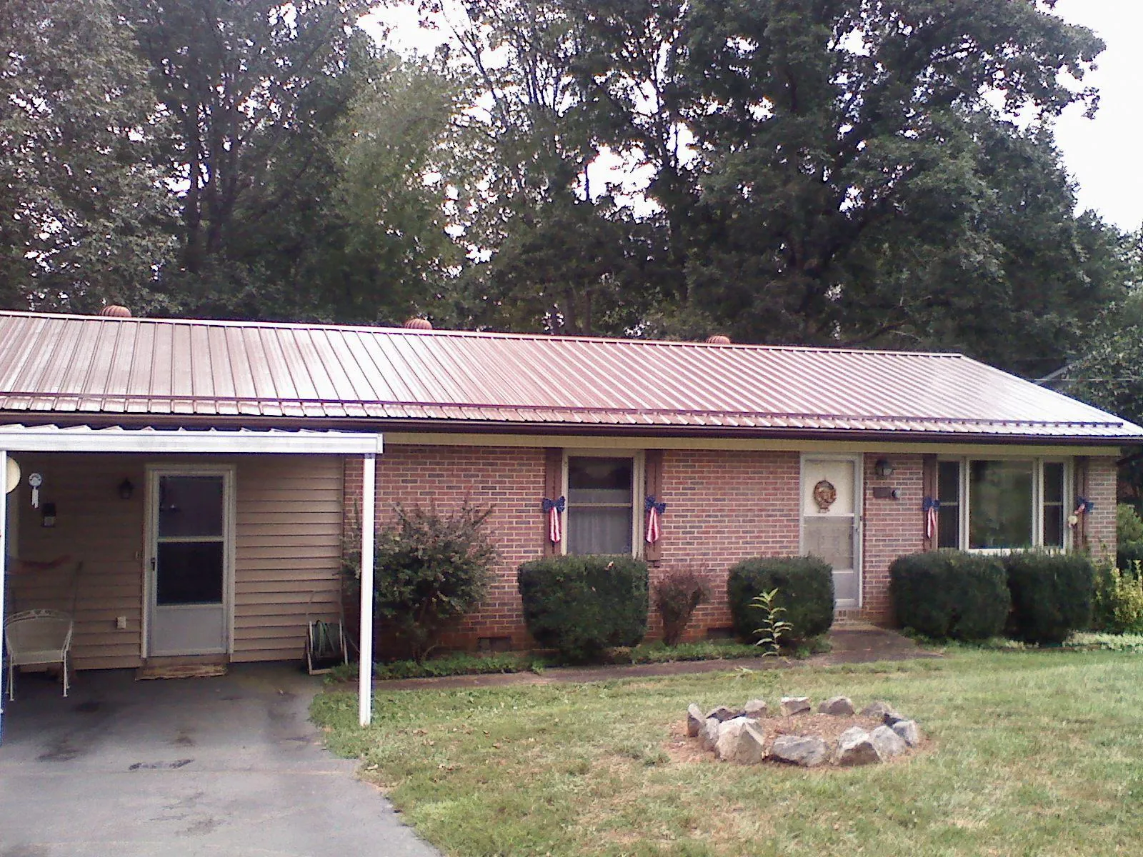 Bronze metal roof and carport on a brick ranch home — Roof Repair work by our crew in Schuylkill Haven